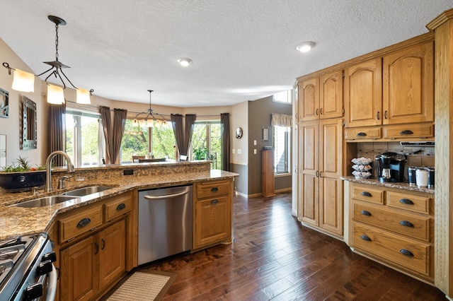 14573 Krypton St NW, Ramsey, MN 55303 - kitchen featuring stainless steel appliances, a sink, light stone countertops, dark wood finished floors, and hanging light fixtures