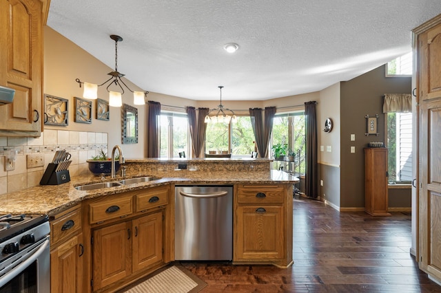 14573 Krypton St NW, Ramsey, MN 55303 - kitchen featuring stainless steel appliances, a sink, a peninsula, a textured ceiling, and dark wood-style floors