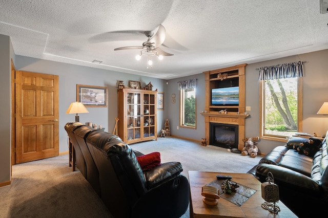 14573 Krypton St NW, Ramsey, MN 55303 - living room featuring light colored carpet, a ceiling fan, a large fireplace, a textured ceiling, and baseboards