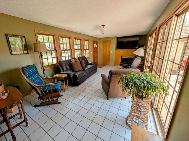 617 9th St, Montevideo, MN 56265 - tiled living area featuring plenty of natural light, a textured ceiling, and a fireplace
