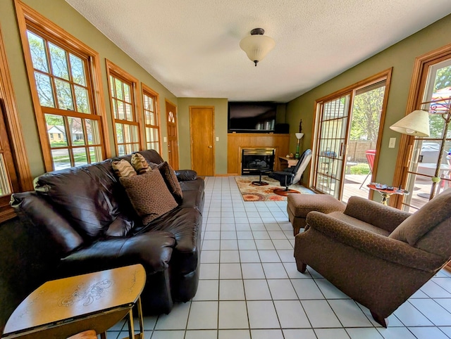 617 9th St, Montevideo, MN 56265 - living room with light tile patterned flooring, a textured ceiling, and a fireplace