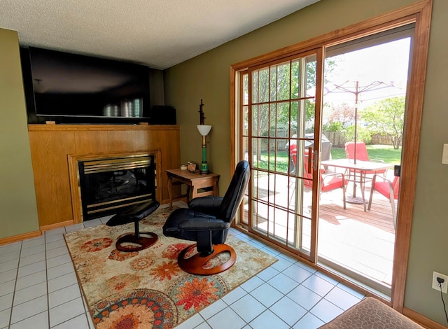 617 9th St, Montevideo, MN 56265 - living area with light tile patterned floors, a glass covered fireplace, and a textured ceiling