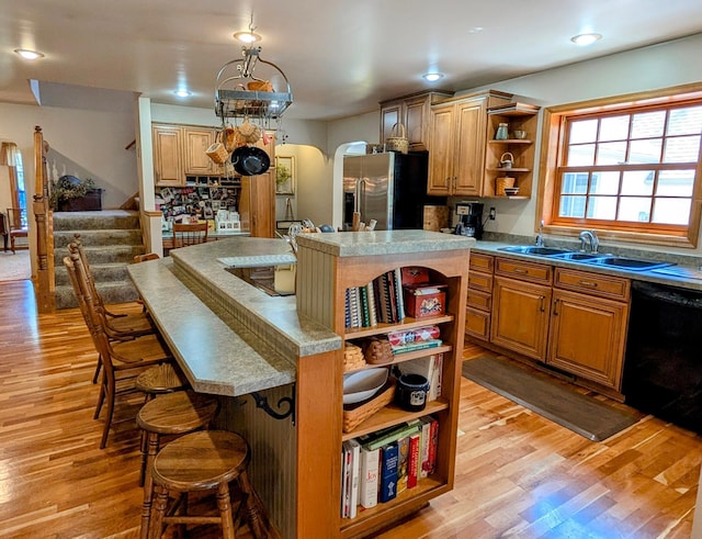 617 9th St, Montevideo, MN 56265 - kitchen featuring open shelves, stainless steel fridge with ice dispenser, dishwasher, a sink, and arched walkways