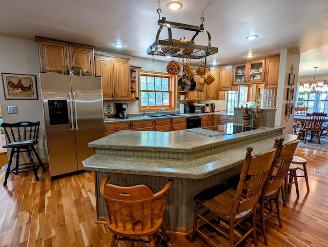 617 9th St, Montevideo, MN 56265 - kitchen featuring black appliances, brown cabinets, light wood-style flooring, open shelves, and recessed lighting