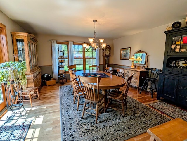 617 9th St, Montevideo, MN 56265 - dining area with a chandelier and light wood-type flooring