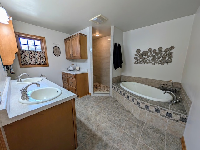 617 9th St, Montevideo, MN 56265 - bathroom with double vanity, a garden tub, a tile shower, and tile patterned floors