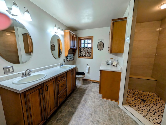 617 9th St, Montevideo, MN 56265 - bathroom with toilet, tiled shower, double vanity, and tile patterned flooring