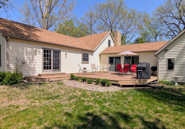617 9th St, Montevideo, MN 56265 - rear view of house with a chimney, a lawn, a deck, and roof with shingles