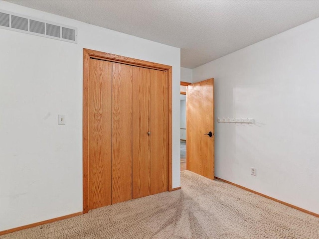 30703 Lakeview Dr, Breezy Point, MN 56472 - unfurnished bedroom with carpet floors, a closet, baseboards, and a textured ceiling