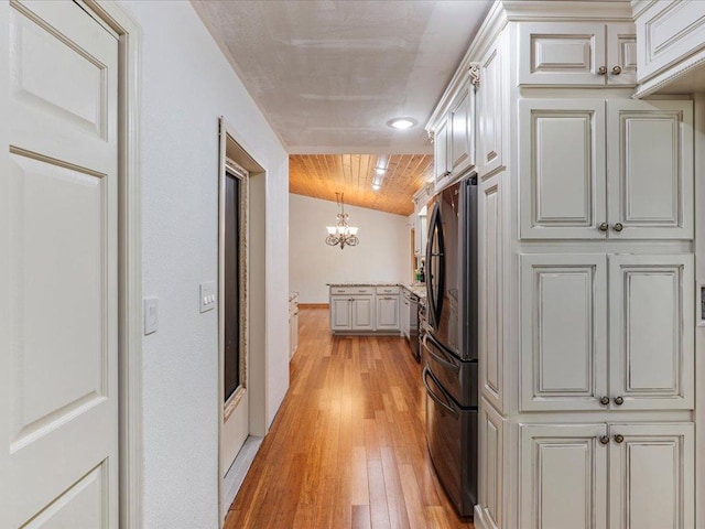 30703 Lakeview Dr, Breezy Point, MN 56472 - laundry room with a chandelier, light wood-type flooring, cabinet space, and separate washer and dryer