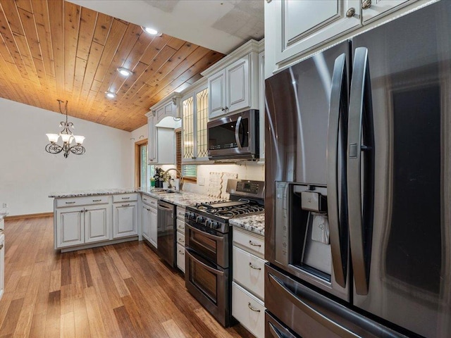 30703 Lakeview Dr, Breezy Point, MN 56472 - kitchen featuring appliances with stainless steel finishes, a peninsula, a chandelier, light stone countertops, and decorative light fixtures