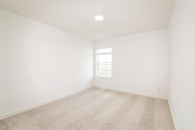 carpeted spare room with baseboards