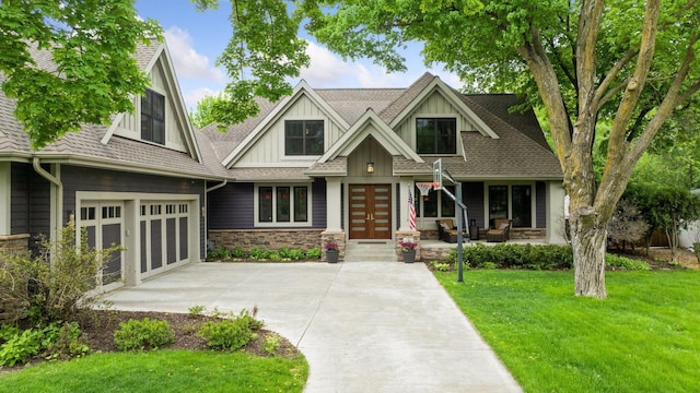 154 Babcock Ln, Wayzata, MN 55391 - view of front facade with concrete driveway, board and batten siding, a front yard, stone siding, and french doors