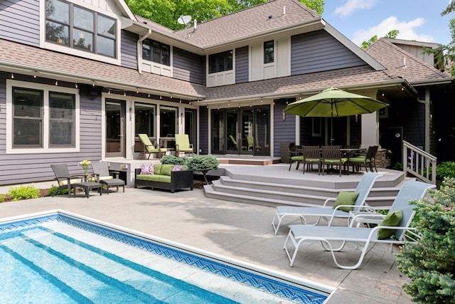 154 Babcock Ln, Wayzata, MN 55391 - rear view of house with outdoor lounge area, roof with shingles, a patio, an outdoor pool, and outdoor dining area