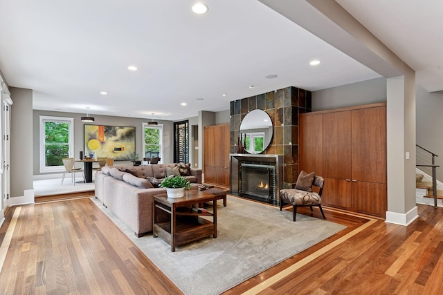 154 Babcock Ln, Wayzata, MN 55391 - living area featuring baseboards, a fireplace, light wood-style flooring, recessed lighting, and stairway