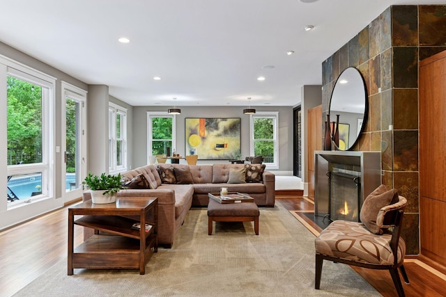 154 Babcock Ln, Wayzata, MN 55391 - living room featuring light wood-style floors, plenty of natural light, recessed lighting, and a fireplace with flush hearth