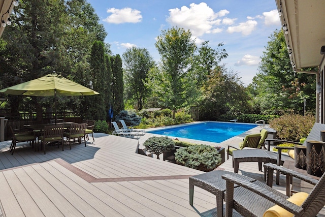 154 Babcock Ln, Wayzata, MN 55391 - swimming pool with a deck, outdoor dining area, and view of wooded area
