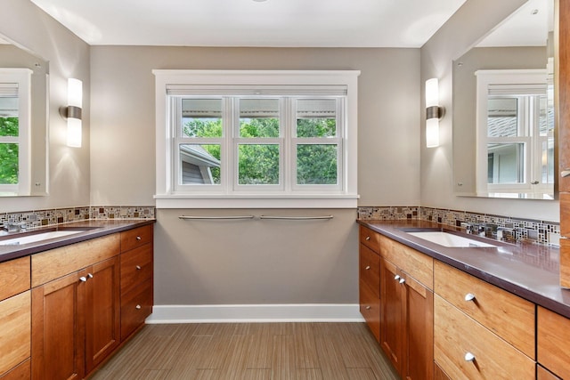 154 Babcock Ln, Wayzata, MN 55391 - full bathroom featuring two vanities, baseboards, and backsplash