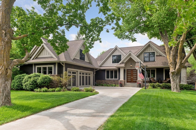 154 Babcock Ln, Wayzata, MN 55391 - craftsman inspired home with board and batten siding, french doors, a front lawn, concrete driveway, and stone siding