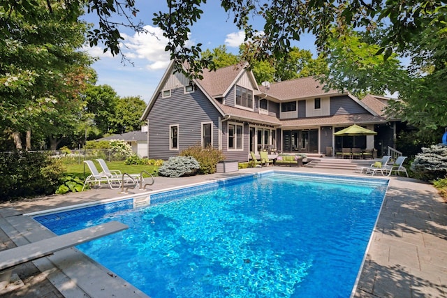 154 Babcock Ln, Wayzata, MN 55391 - outdoor pool featuring a patio, a diving board, and an outdoor hangout area