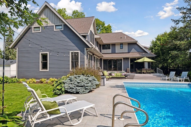 154 Babcock Ln, Wayzata, MN 55391 - rear view of house featuring a patio area, board and batten siding, and an outdoor pool