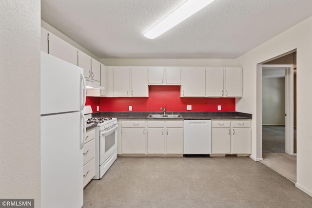 11031 Oregon Cir Unit 58, Bloomington, MN 55438 - kitchen with white appliances, under cabinet range hood, a sink, dark countertops, and a textured ceiling
