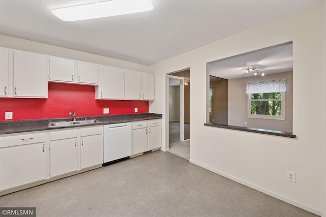 11031 Oregon Cir Unit 58, Bloomington, MN 55438 - kitchen featuring dishwasher, a sink, white cabinets, dark countertops, and a textured ceiling