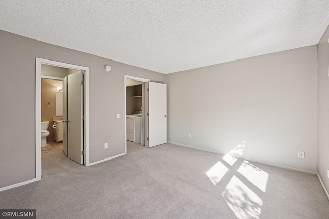 11031 Oregon Cir Unit 58, Bloomington, MN 55438 - unfurnished bedroom with washing machine and clothes dryer, carpet floors, a textured ceiling, baseboards, and connected bathroom