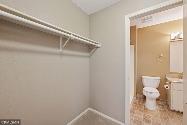 11031 Oregon Cir Unit 58, Bloomington, MN 55438 - bathroom with vanity, toilet, baseboards, and a shower