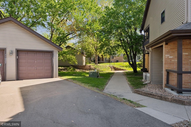 11031 Oregon Cir Unit 58, Bloomington, MN 55438 - view of yard with driveway and an outdoor structure