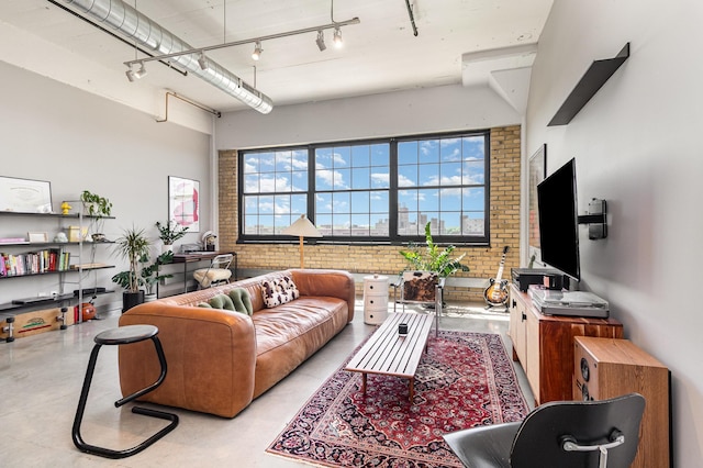 730 Stinson Blvd Unit 406, Minneapolis, MN 55413 - living room with brick wall, concrete floors, and track lighting