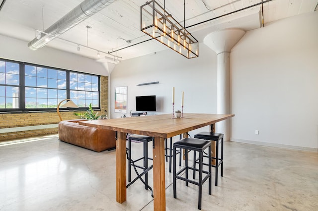 730 Stinson Blvd Unit 406, Minneapolis, MN 55413 - kitchen with finished concrete flooring, butcher block countertops, open floor plan, a kitchen breakfast bar, and baseboards