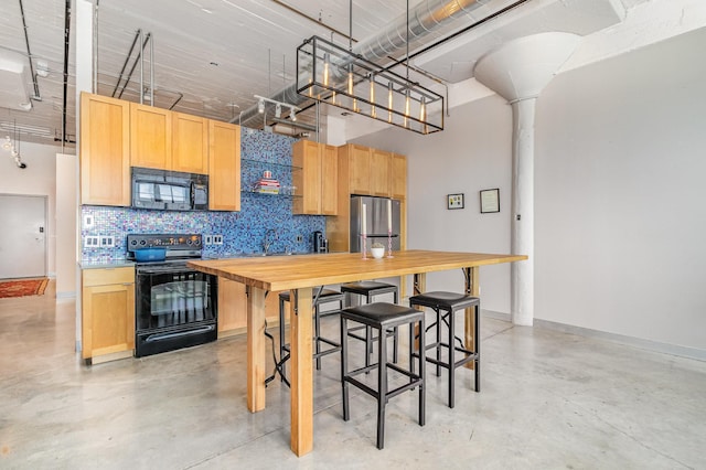 730 Stinson Blvd Unit 406, Minneapolis, MN 55413 - kitchen featuring black appliances, finished concrete flooring, light brown cabinetry, decorative backsplash, and wooden counters