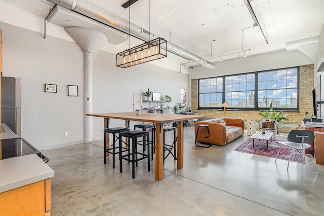730 Stinson Blvd Unit 406, Minneapolis, MN 55413 - dining area featuring concrete floors, baseboards, and brick wall