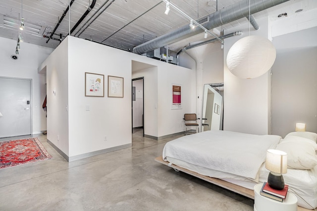 730 Stinson Blvd Unit 406, Minneapolis, MN 55413 - bedroom featuring a towering ceiling, finished concrete floors, and track lighting
