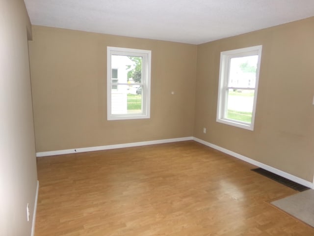 5921 Xerxes Ave S, Minneapolis, MN 55410 - unfurnished room featuring plenty of natural light, light wood-type flooring, and baseboards