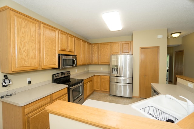 1675 Skywood Ln, Eagan, MN 55122 - kitchen with stainless steel appliances, a sink, and light countertops