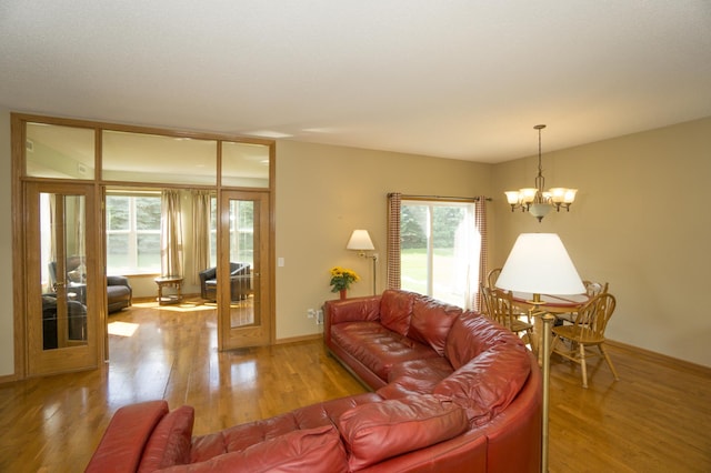 1675 Skywood Ln, Eagan, MN 55122 - living room with healthy amount of natural light, a chandelier, and wood finished floors