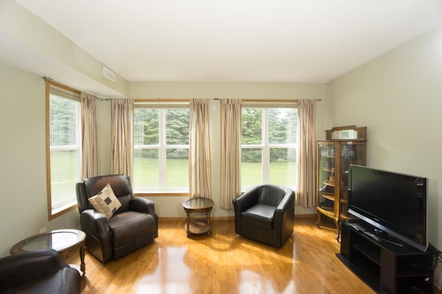 1675 Skywood Ln, Eagan, MN 55122 - sitting room with wood finished floors and plenty of natural light