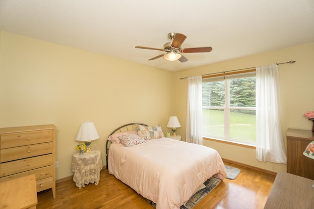 1675 Skywood Ln, Eagan, MN 55122 - bedroom with wood finished floors, ceiling fan, and baseboards