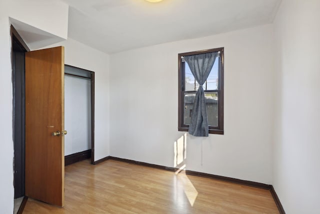 1264 Snelling Ave N, Saint Paul, MN 55108 - unfurnished bedroom with light wood-style flooring and baseboards