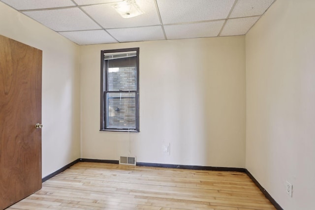 1264 Snelling Ave N, Saint Paul, MN 55108 - unfurnished room with a paneled ceiling, wood-type flooring, and baseboards