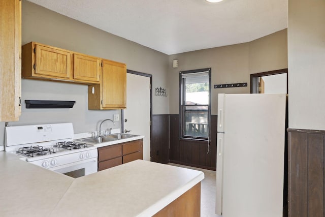 1264 Snelling Ave N, Saint Paul, MN 55108 - kitchen with white appliances, a sink, light countertops, and a peninsula