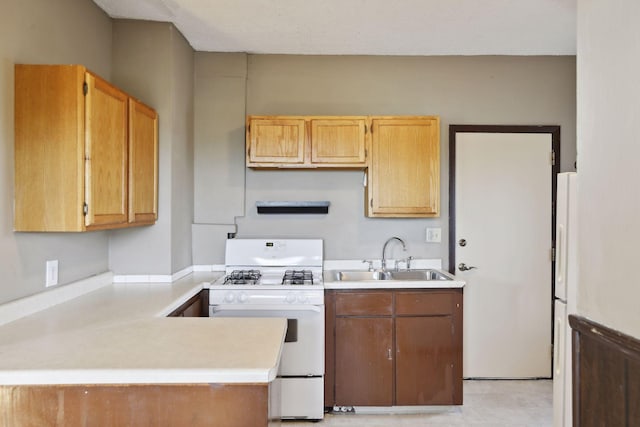 1264 Snelling Ave N, Saint Paul, MN 55108 - kitchen featuring white appliances, a sink, light countertops, and a peninsula