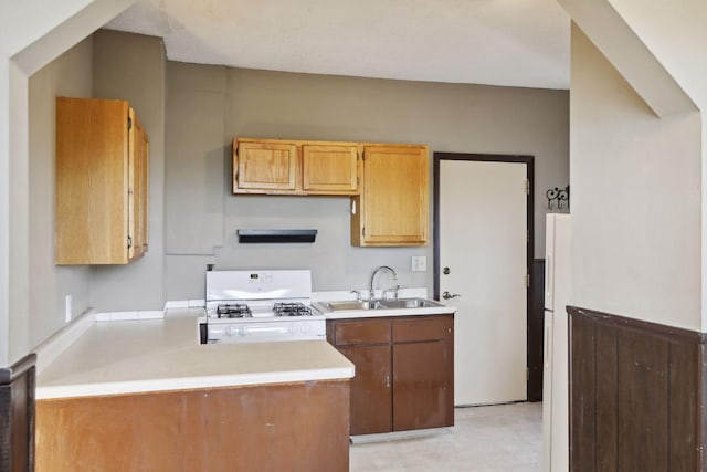 1264 Snelling Ave N, Saint Paul, MN 55108 - kitchen featuring a sink, white range with gas cooktop, light countertops, and a peninsula