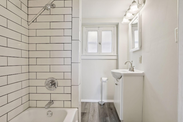 1264 Snelling Ave N, Saint Paul, MN 55108 - bathroom featuring shower / tub combination, wood finished floors, and vanity