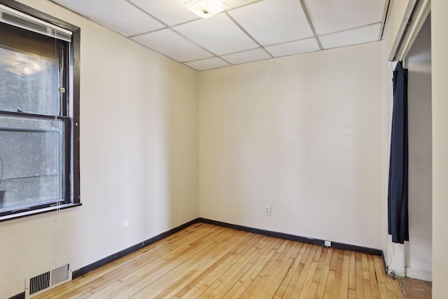 1264 Snelling Ave N, Saint Paul, MN 55108 - unfurnished room featuring a paneled ceiling, light wood-style floors, and baseboards