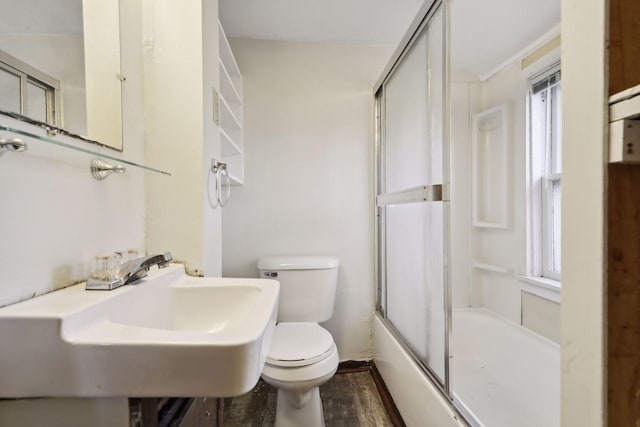 1264 Snelling Ave N, Saint Paul, MN 55108 - full bathroom featuring toilet, plenty of natural light, a sink, and bath / shower combo with glass door