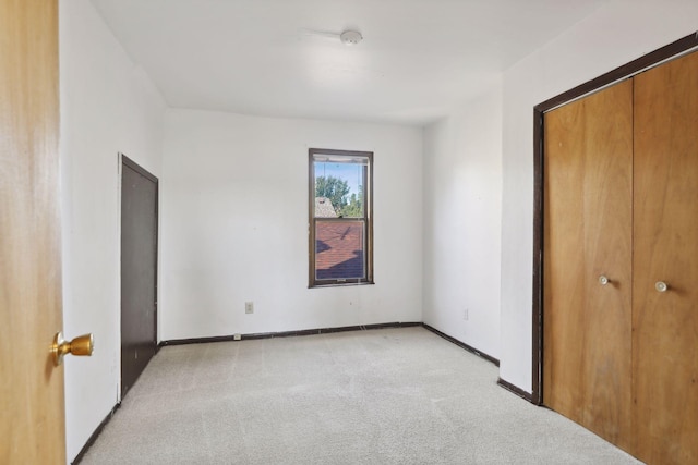 1264 Snelling Ave N, Saint Paul, MN 55108 - unfurnished bedroom featuring light carpet, a closet, and baseboards