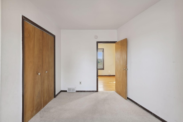 1264 Snelling Ave N, Saint Paul, MN 55108 - unfurnished bedroom featuring a closet, carpet, and baseboards